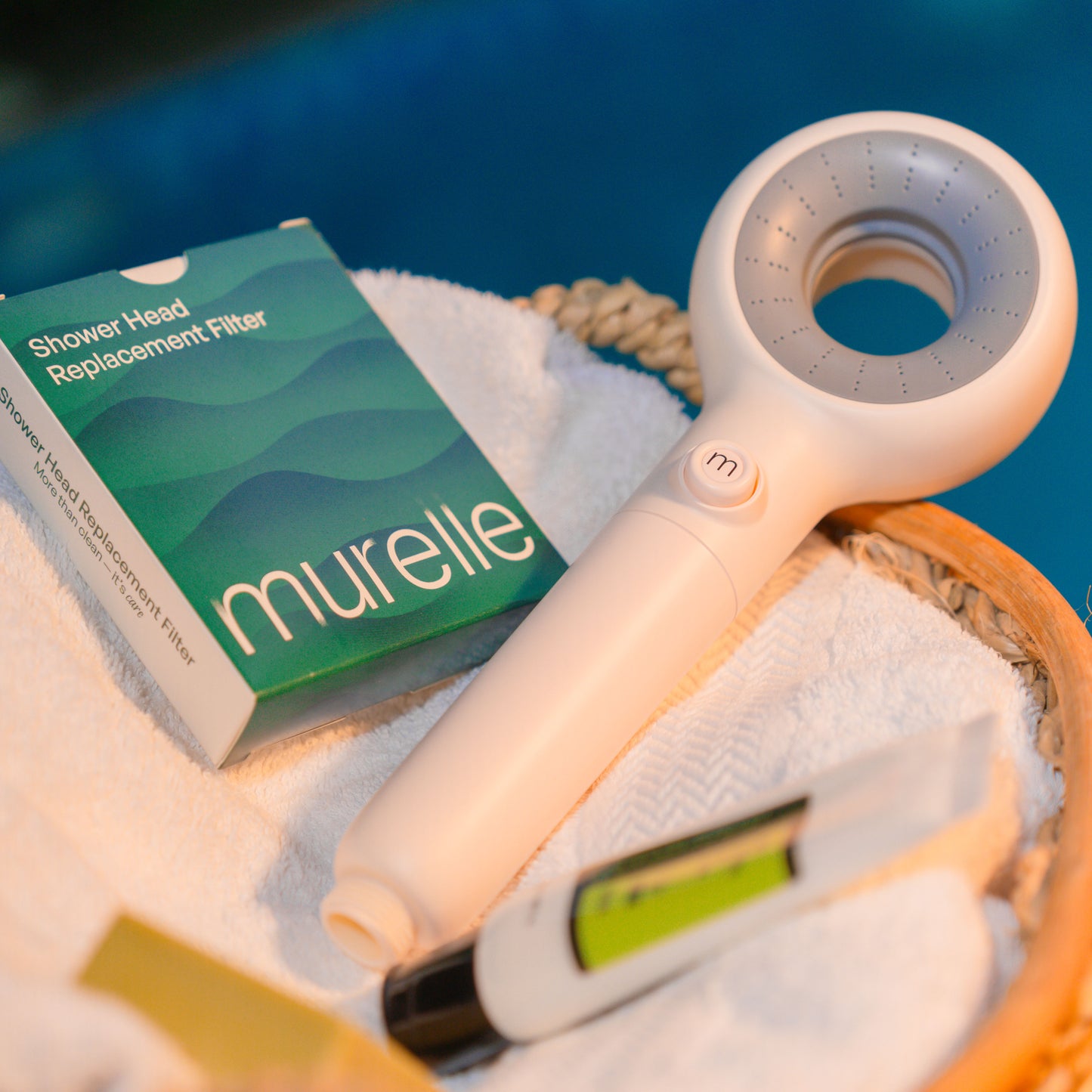 Murelle Shower head and replacement filter with packaging on a towel