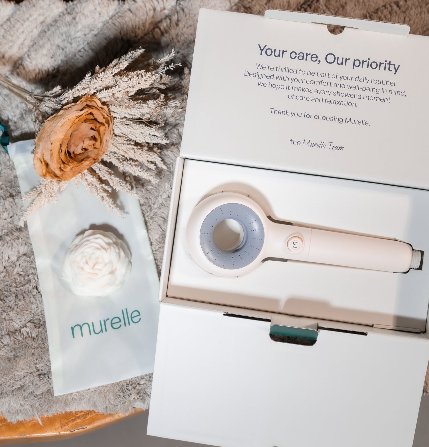 Murelle product packaging with a floral arrangement on a textured surface