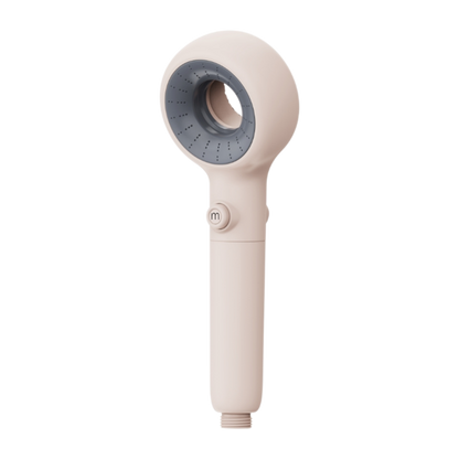Beige handheld Murelle shower head with gray nozzle on a white background