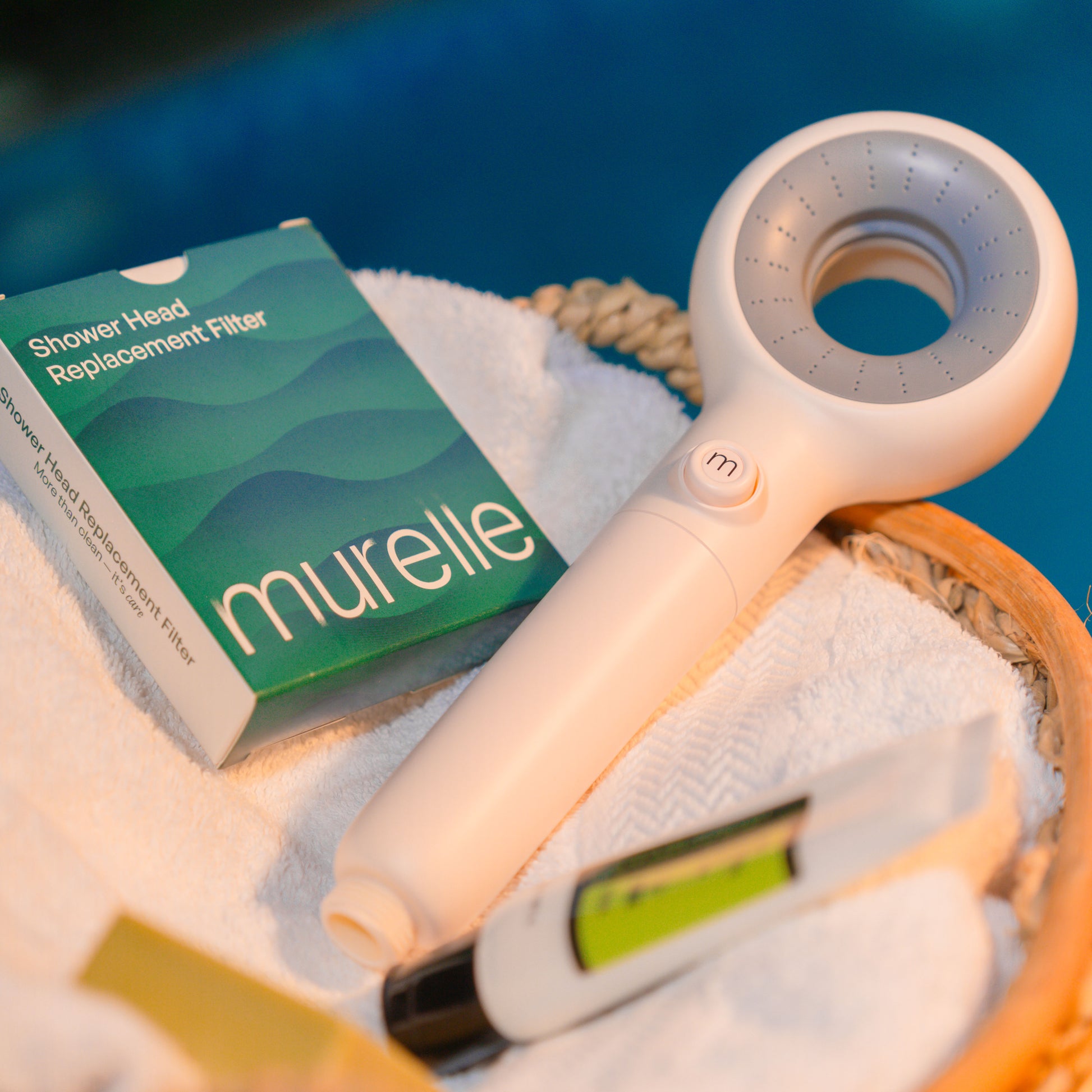 Murelle Shower head and replacement filter with packaging on a towel