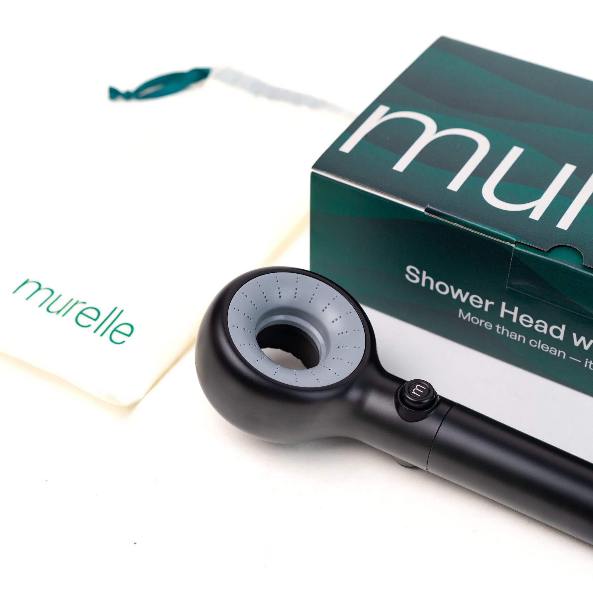Black shower head with packaging labeled 'murelle' on a white background